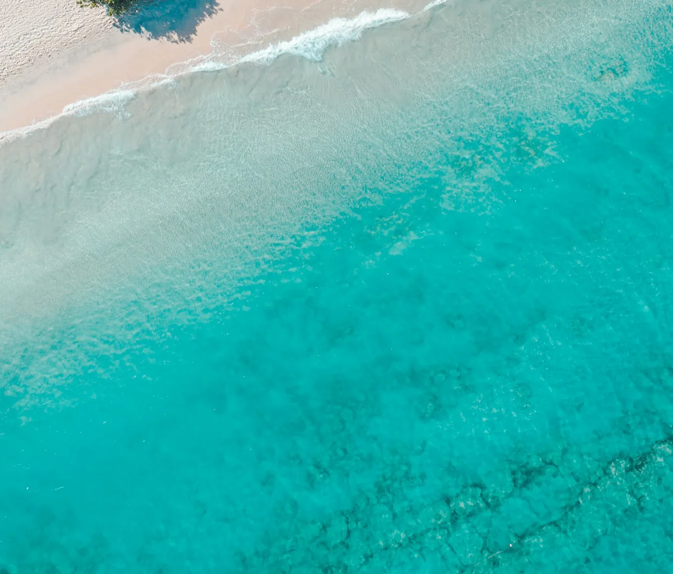 Aerial view of the turquoise sea and white sand at Grand Anse Beach, Grenada